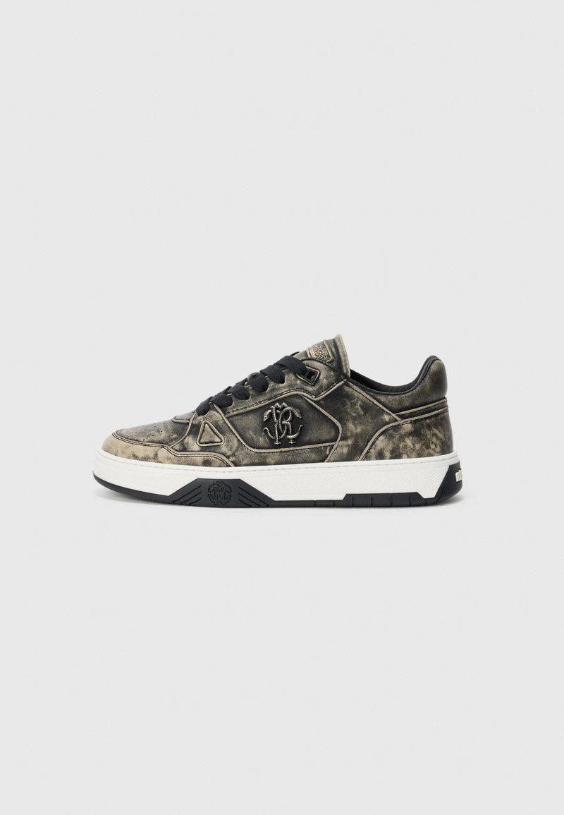 Low-top sneaker with stained black and beige leather, black laces, and a white sole with black accents and logo embroidery on the side.