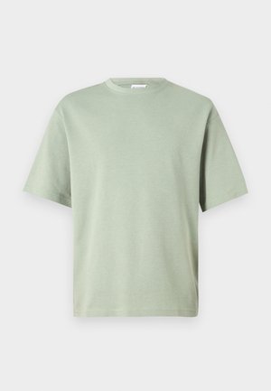 Light green cotton t-shirt with a round neckline and short sleeves. The fabric has a smooth texture and is unembellished with any patterns.