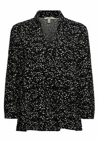 Blouse noire à manches longues avec motif abstrait de points blancs, boutonnée sur le devant, col et ourlet style péplum.