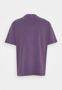 Purple cotton t-shirt with short sleeves, a round neckline, and a relaxed fit. The fabric has a soft, smooth texture with no patterns.