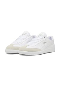 White sneakers with a smooth leather upper and light grey suede accents, featuring a round toe, lace-up closure, and textured white sole.