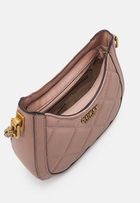 Borsa a tracolla in rosa pallido trapuntata con superficie testurizzata, hardware dorato, chiusura a zip e tasca interna. Logo impresso sul lato.