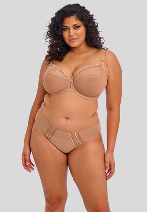 Beha- en slipset in lichtbeige, met textuurdetails en decoratieve accenten op de bovenrand en de tailleband. Gladde stof.