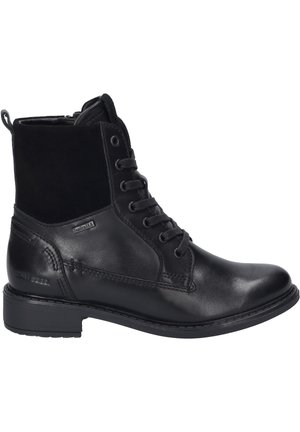 Bottines noires en cuir et daim, dotées d'un laçage, d'un bout rond et d'une semelle en caoutchouc texturé. Doublure imperméable incluse.