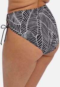 Hooggesneden bikini ondergoed met een zwart-wit bladerenpatroon, gemaakt van gladde stof; met zijstrikjes voor een verstelbare pasvorm.