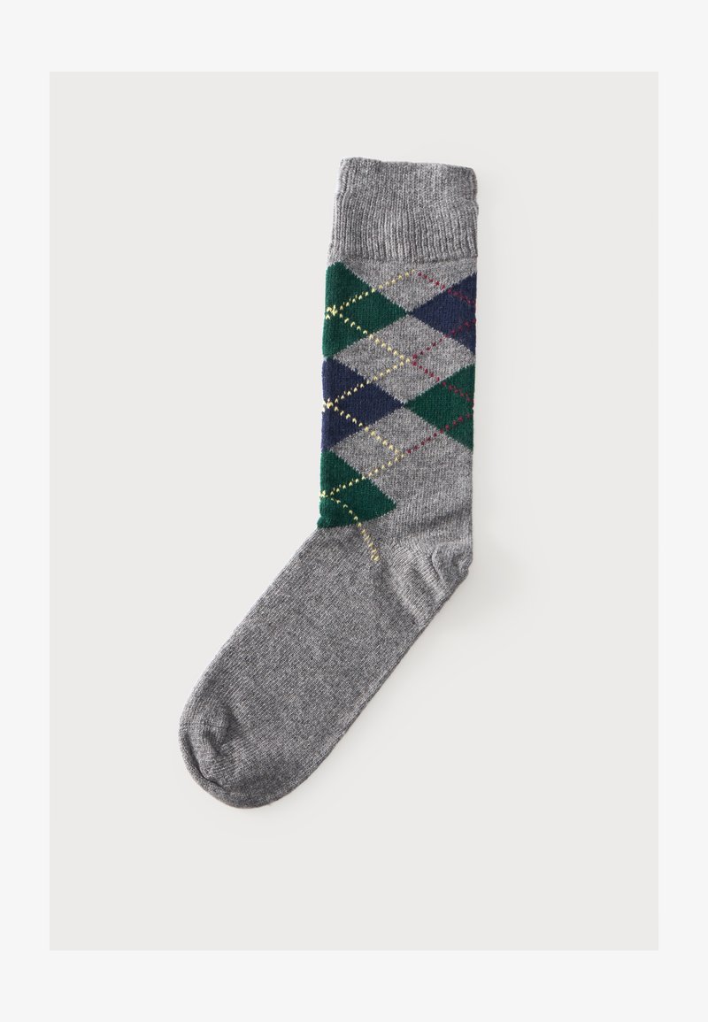 Une chaussette grise unique avec un motif losanges vert, marine et gris clair et des lignes losanges brodées en jaune et rouge.