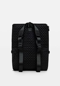 Black backpack with a woven texture, featuring two adjustable straps, a top handle, and a zippered closure, designed for functionality.
