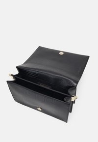 Borsa in pelle nera strutturata con hardware dorato, aperta per rivelare due scomparti. Chiusura a scatto semplice e finiture interne lisce.