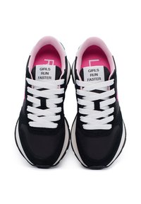 Black sneakers with white laces and a pink inner lining. Features a "GIRLS RUN FASTER" label on the tongue and a textured upper design.