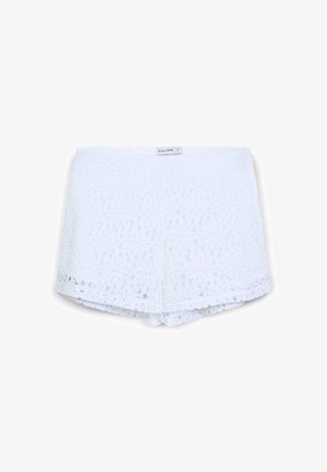 White lace shorts featuring a geometric pattern, scalloped hem, and a smooth elastic waistband. Label reads "CALLIOPE."