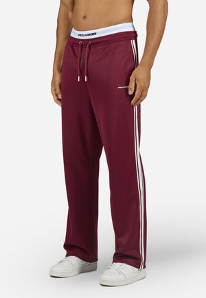 Maroon sweatpants with white side stripes, drawstring waist, and logo print on the left thigh. Made from a smooth, athletic material.