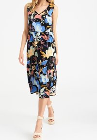 Robe sans manches à imprimé floral noir avec des motifs bleus, roses et jaunes ; longueur genou avec un décolleté en V et une taille froncée.
