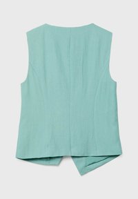 Veste sans manches bleu sarcelle clair avec une coupe cintrée et des panneaux arrière légèrement superposés sur un fond uni.