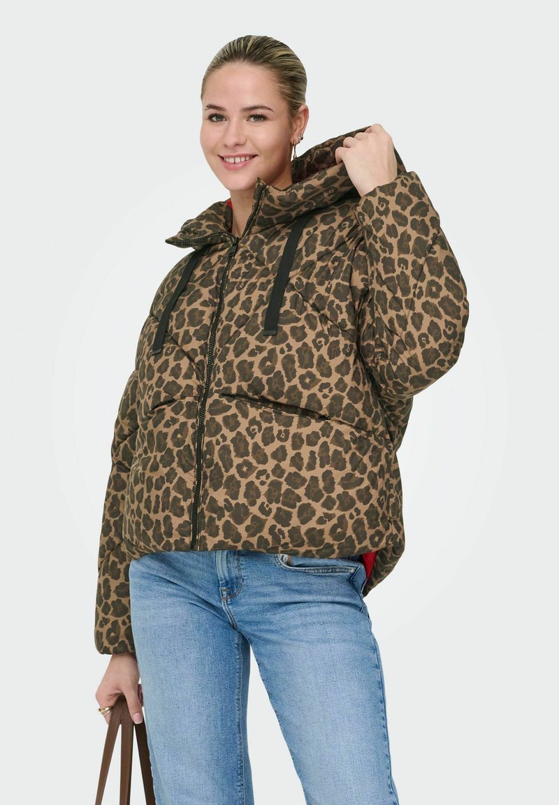 Padded leopard print jacket in brown and black, featuring a zip front, large hood, and double pocket design. Styled with blue jeans.