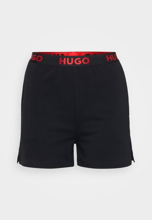 Black shorts made of soft fabric with a wide red waistband featuring "HUGO" logo, minimal side slits for ease of movement.