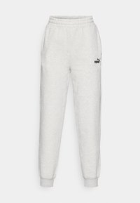 Pantalon de survêtement gris clair en tissu doux, avec une taille élastique, des poignets côtelés et un petit logo Puma noir sur la cuisse gauche.