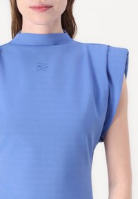 Blue short-sleeve top with a high collar and structured shoulder design. Features subtle embroidered detailing on the front. Smooth texture.