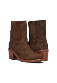 Brown suede ankle boots with a rounded toe and stacked heel. Smooth texture and side detailing. Minimalist design with a subtle brand tag.