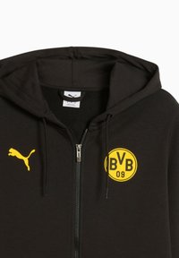 Sort zip-up hoodie lavet af en bomuldsblanding. Har et gult Puma-logo på brystet og et cirkulært gult mærke med "BVB 09." Belagte lynlåse.