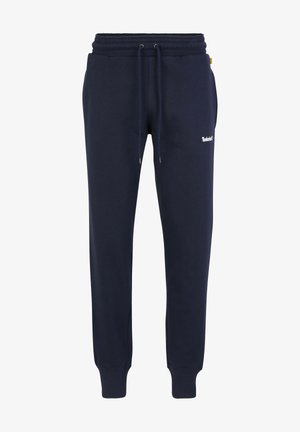 Marineblå sweatpants i blødt stof med elastisk taljebånd med snøre, ribstrikkede manchetter og hvidt logo på venstre lår.