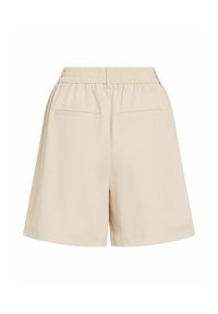 Short beige taille haute avec ceinture élastique et deux poches arrière horizontales, présenté sur fond blanc.