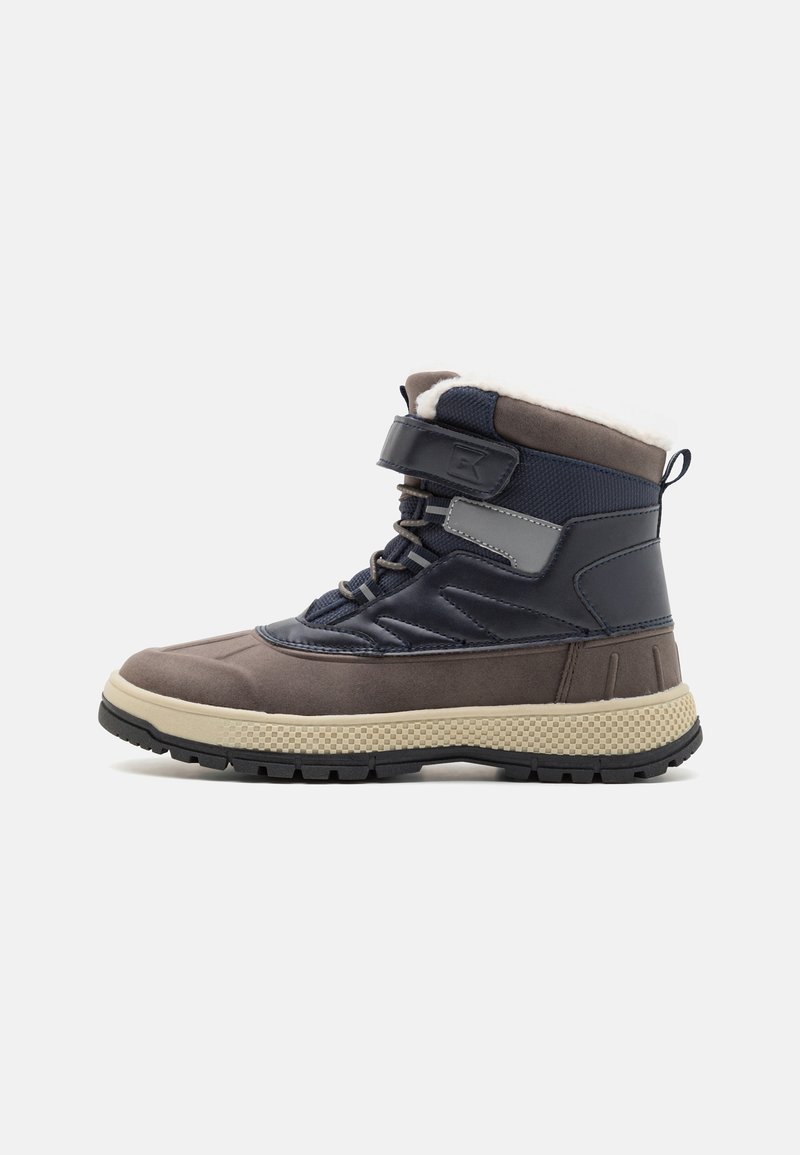 Brown and navy winter boots with a textured rubber sole, soft lining, Velcro strap, and lacing system. Reinforced toe design for durability.