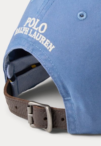 Hele sinine Polo Ralph Laureni nokats, millel on tikitud logo ja reguleeritav pruun nahast rihm metallist pandlaga.