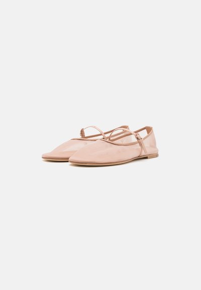 Pink flat shoes with a soft material, a pointed toe design, and a thin ankle strap. The sole is flat and made of light-colored rubber.