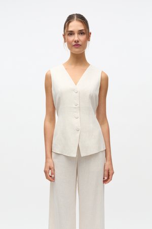 Light beige sleeveless linen vest with a V-neckline, two front pockets, and five round buttons, paired with matching wide-leg linen pants.