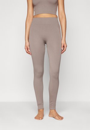 Leggings cu nervuri, cu talie medie, într-o nuanță deschisă de taupe, care oferă o fit strânsă și design până la gleznă, realizate dintr-un amestec elastic de bumbac.
