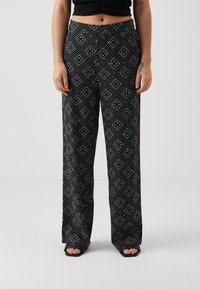 Sorte, mønstrede vide bukser med et geometrisk design i hvidt og blåt, lavet af et blødt stof og med elastisk talje.