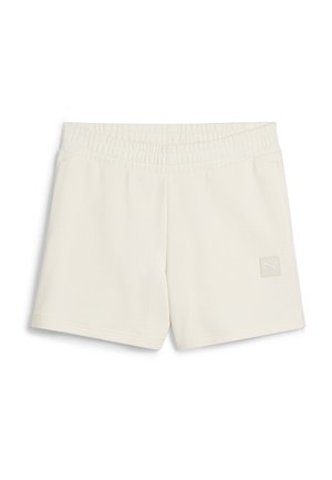 Cream-colored athletic shorts with an elastic waistband, featuring a small white logo patch on the front and smooth fabric texture.