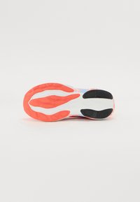 Shoe outsole featuring a textured pattern in coral, white, and black with a curved design and flex grooves for improved traction.