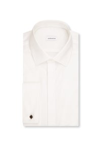 Chemise blanche pliée avec un col classique et une seule manchette sur la manche gauche, étiquette de la marque visible à l'intérieur du col.