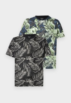 Two short-sleeve crew neck t-shirts with tropical leaf patterns, one in black and white, the other in green and blue tones.