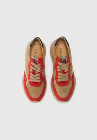 Baskets en suède tan et rouge avec des lacets beiges, des accents en imprimé léopard et une semelle en caoutchouc lisse. Dotées d'une semelle intérieure rembourrée pour plus de confort.