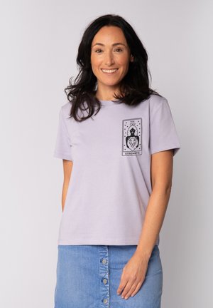 Light purple cotton t-shirt with a round neckline and short sleeves. Features a black graphic print of a woman and a lion, labeled "STRENGTH."