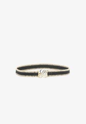 Black woven belt with beige zigzag trim and gold monogram buckle centered on a white background.