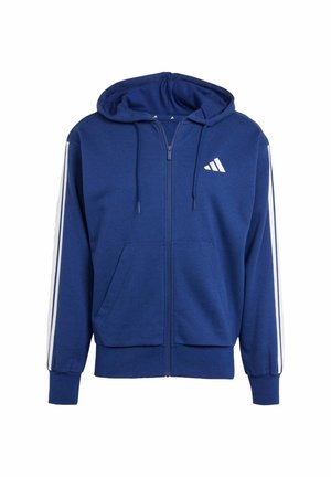 Haut à zip bleu en tissu doux ; comprend une poche kangourou, des rayures blanches sur les côtés et un logo sur la partie gauche de la poitrine. Capuche réglable.