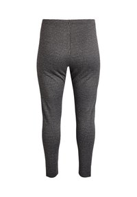 Melnā un baltā houndstooth raksta legingi, kas izgatavoti no elastīga materiāla, ar pieguļošu dizainu un augstu jostasvietu.
