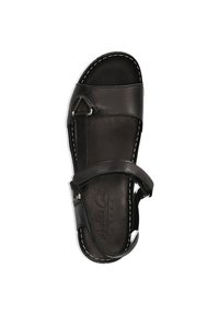 Schwarze Sandale aus Leder mit zwei verstellbaren Riemen, einer abgerundeten Fußspitze und sichtbaren weißen Nähten entlang der Kanten. Flaches Sohlendesign.