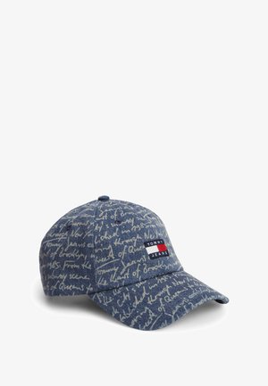 Denim baseball cap with light handwritten script pattern and a rectangular Tommy Jeans logo patch in red, white, and blue on the front.