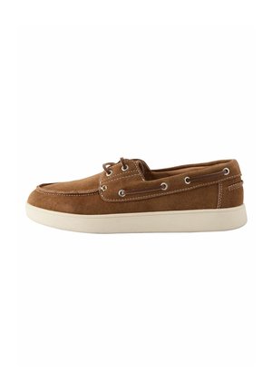 Brown suede boat shoe with white sole, lace details along the side, and visible stitching on a plain white background.