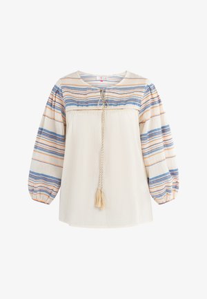 Lekka, kremowa bluzka z poziomymi niebieskimi i pomarańczowymi paskami, okrągłym dekoltem i bufkami. Posiada sznurek z detalem w postaci frędzla.