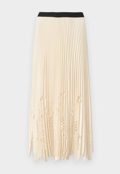 Πλισέ φούστα σε κρεμ χρώμα με μαύρη ελαστική ζώνη στη μέση· διαθέτει διακοσμητικές κοπές με λουλουδάτα μοτίβα κατά μήκος του τελειώματος για υφή και οπτικό ενδιαφέρον.