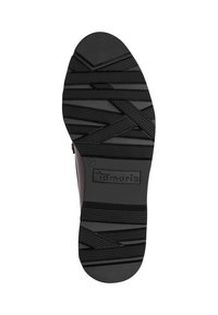 Semelle de chaussure noire avec motif géométrique, nom de la marque "Tamaris," et taille 37 visibles près du talon.