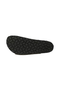 Suola di scarpa in gomma nera con un motivo circolare, caratterizzata da una punta arrotondata e un bordo liscio per una maggiore flessibilità e aderenza.