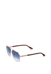 Lunettes de soleil style aviateur avec montures en métal doré, verres dégradés bleus et branches écaille marron sur fond blanc.