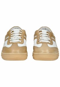 Beige leather sneakers with white accents, featuring round laces, a textured sole, and side stripes. Smooth finish with minimal branding.
