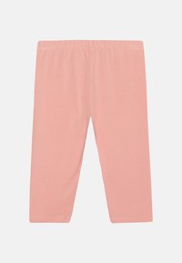 Ljust rosa leggings gjorda av ett mjukt, stretchigt material. Har en elastisk midja och inga fickor eller ytterligare dekorationer.